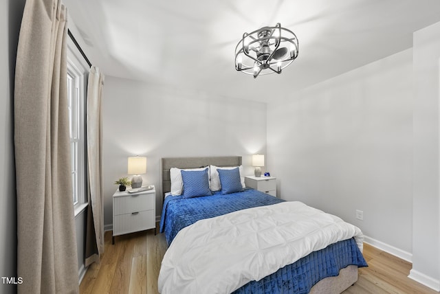 2704 Farnborough Rd, Raleigh, NC 27613 - bedroom featuring a chandelier and light wood-type flooring