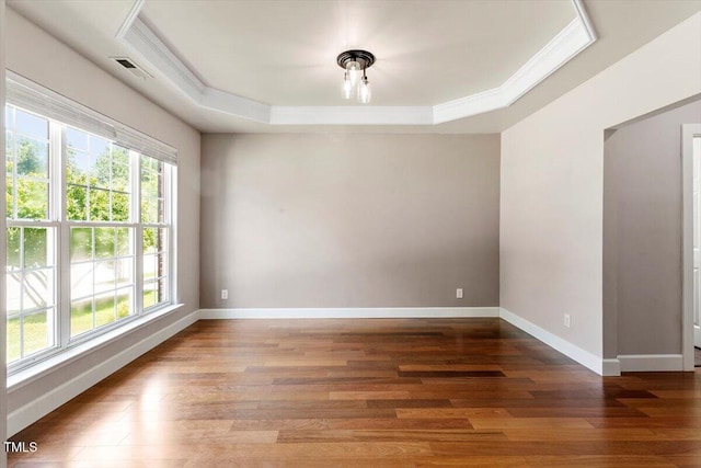 7414 Brandon Allen Ave, Raleigh, NC 27613 - spare room featuring a raised ceiling, wood finished floors, and crown molding