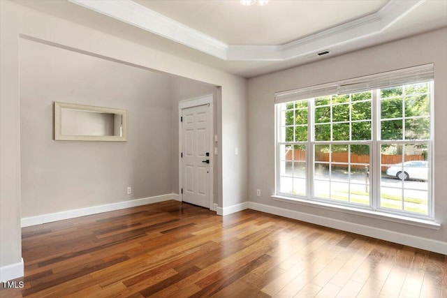 7414 Brandon Allen Ave, Raleigh, NC 27613 - foyer with ornamental molding, a tray ceiling, and wood-type flooring