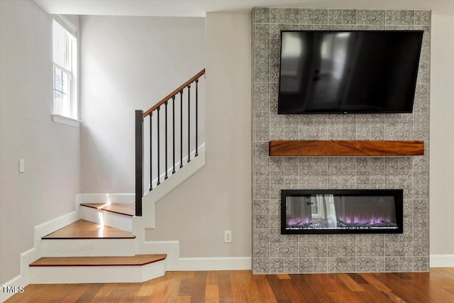 7414 Brandon Allen Ave, Raleigh, NC 27613 - staircase featuring wood finished floors and a fireplace
