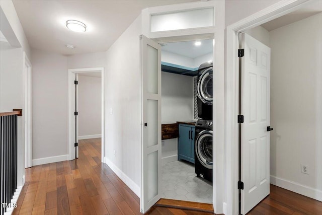 7414 Brandon Allen Ave, Raleigh, NC 27613 - washroom featuring estacked washer and dryer, cabinet space, and hardwood / wood-style flooring
