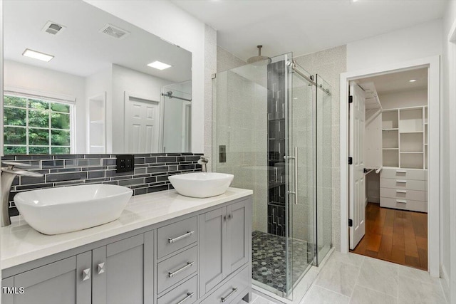 7414 Brandon Allen Ave, Raleigh, NC 27613 - full bath featuring a shower stall, double vanity, tasteful backsplash, and a spacious closet