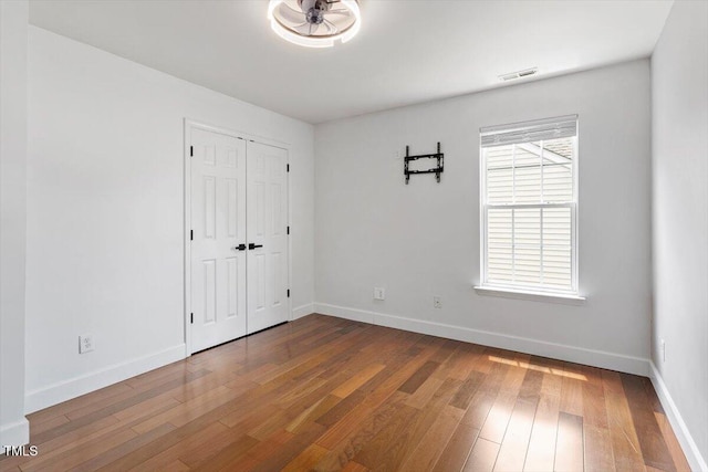 7414 Brandon Allen Ave, Raleigh, NC 27613 - unfurnished bedroom featuring wood-type flooring and a closet