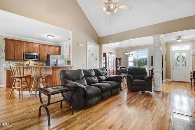 8101 Claybrooke Ct, Willow Springs, NC 27592 - living area with light wood-style flooring, a ceiling fan, ornate columns, a chandelier, and high vaulted ceiling