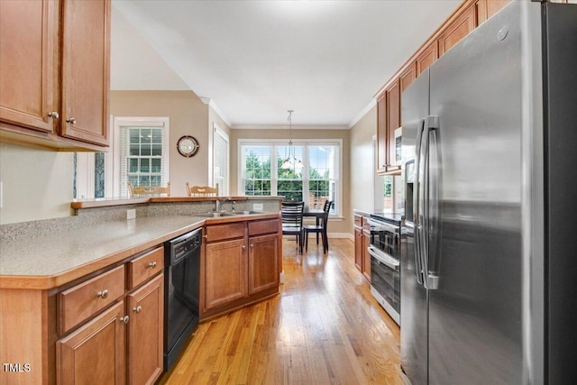8101 Claybrooke Ct, Willow Springs, NC 27592 - kitchen featuring stainless steel appliances, light wood finished floors, crown molding, brown cabinetry, and a peninsula