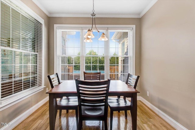 8101 Claybrooke Ct, Willow Springs, NC 27592 - dining space with light wood-style flooring, ornamental molding, and a chandelier