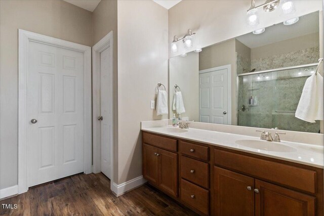 8101 Claybrooke Ct, Willow Springs, NC 27592 - full bathroom with a stall shower, double vanity, and wood finished floors