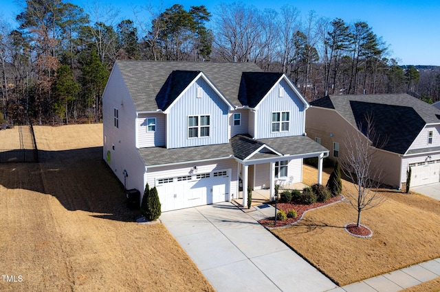 78 N Porcenna Ln, Clayton, NC 27527 - view of front of home featuring board and batten siding, covered porch, a garage, concrete driveway, and roof with shingles
