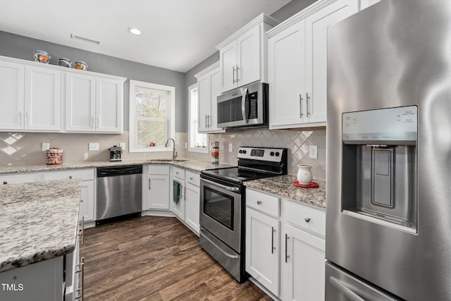 78 N Porcenna Ln, Clayton, NC 27527 - kitchen featuring stainless steel appliances, white cabinets, backsplash, dark wood-style flooring, and recessed lighting