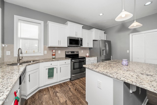 78 N Porcenna Ln, Clayton, NC 27527 - kitchen with appliances with stainless steel finishes, dark wood-style flooring, white cabinetry, tasteful backsplash, and recessed lighting