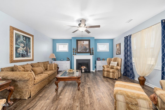 78 N Porcenna Ln, Clayton, NC 27527 - living room featuring wood finished floors, ceiling fan, and a warm lit fireplace