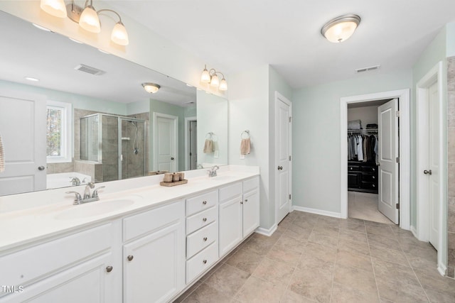 78 N Porcenna Ln, Clayton, NC 27527 - bathroom featuring a stall shower, double vanity, and a spacious closet
