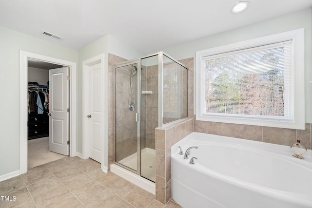 78 N Porcenna Ln, Clayton, NC 27527 - full bath featuring a garden tub, a shower stall, a spacious closet, and tile patterned floors