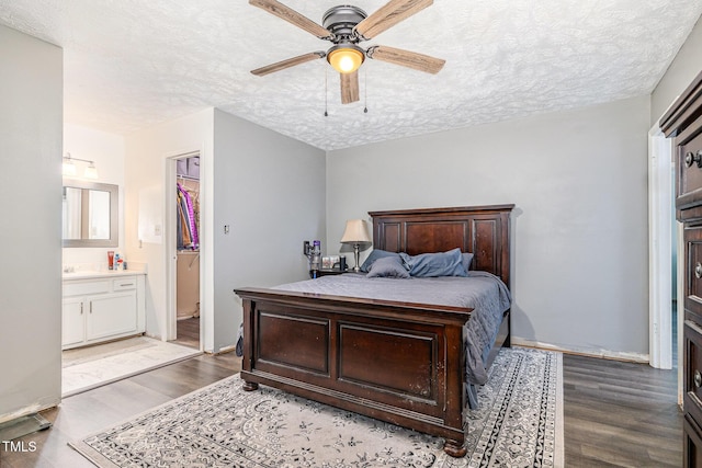 2205 Indigo Bush Pl, Fayetteville, NC 28304 - bedroom featuring wood finished floors, a textured ceiling, ensuite bathroom, and ceiling fan