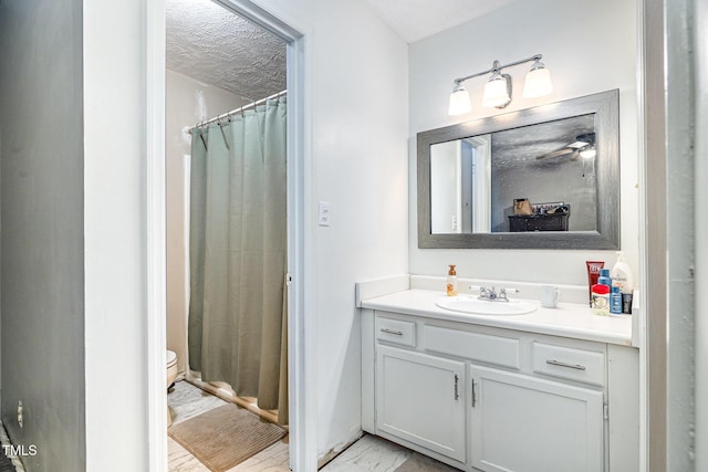 2205 Indigo Bush Pl, Fayetteville, NC 28304 - bathroom featuring marble look tile flooring, vanity, a shower with curtain, and a textured ceiling