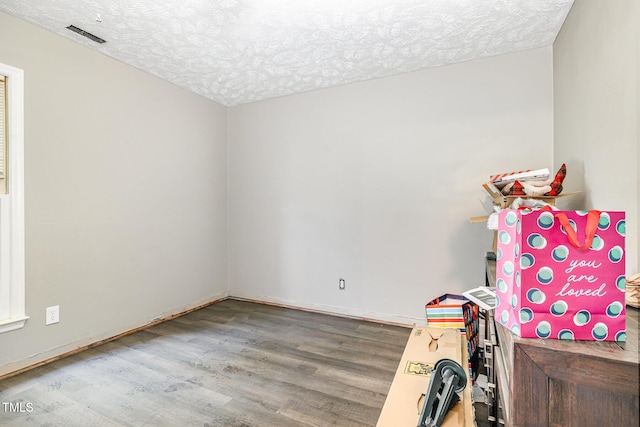2205 Indigo Bush Pl, Fayetteville, NC 28304 - rec room with wood finished floors and a textured ceiling