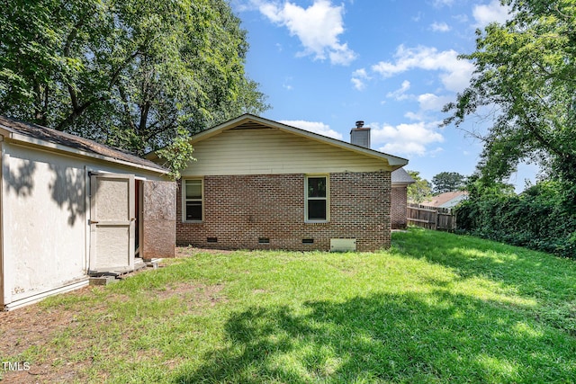 2205 Indigo Bush Pl, Fayetteville, NC 28304 - back of house featuring crawl space, a chimney, brick siding, and an outdoor structure