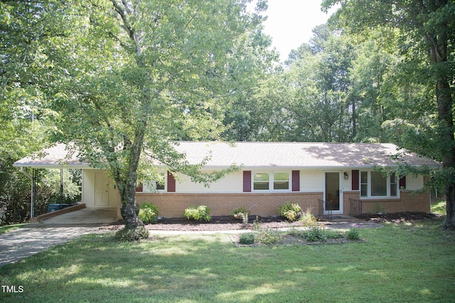 4028 Chaucer Dr, Durham, NC 27705 - ranch-style home with brick siding, an attached carport, a front lawn, and driveway
