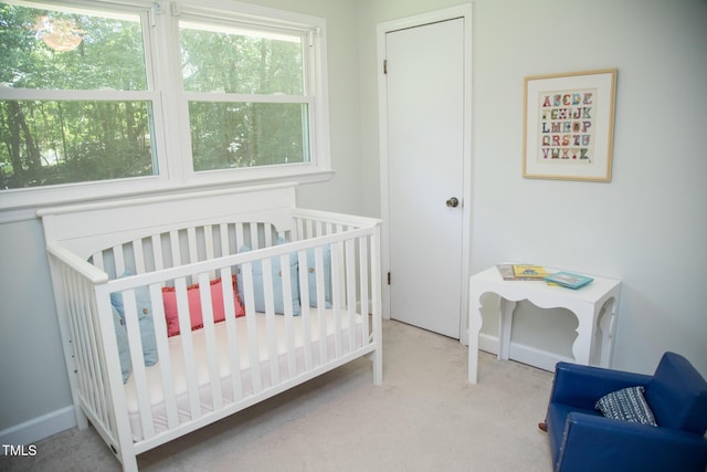 4028 Chaucer Dr, Durham, NC 27705 - carpeted bedroom featuring a crib and baseboards