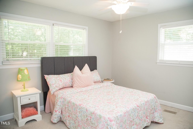 4028 Chaucer Dr, Durham, NC 27705 - carpeted bedroom featuring multiple windows and a ceiling fan