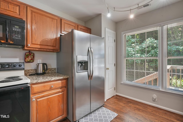 8532 Swarthmore Dr, Raleigh, NC 27615 - kitchen featuring stainless steel fridge, electric range, black microwave, and healthy amount of natural light