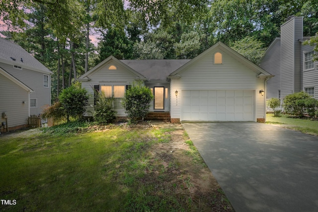 8532 Swarthmore Dr, Raleigh, NC 27615 - view of front of house featuring concrete driveway, a garage, and a yard