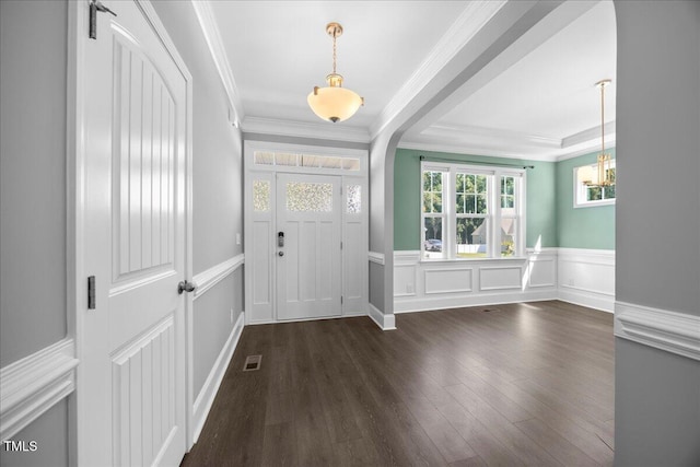 2223 Copper Pond Way, Fuquay Varina, NC 27526 - entryway featuring a chandelier, dark wood-type flooring, crown molding, wainscoting, and a decorative wall