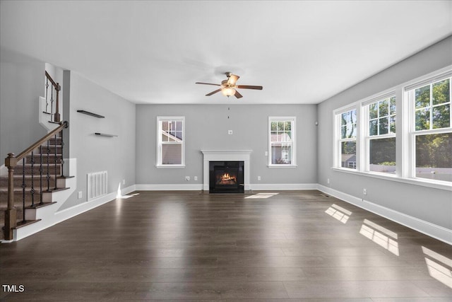 2223 Copper Pond Way, Fuquay Varina, NC 27526 - unfurnished living room with ceiling fan, dark wood-style floors, stairway, and a fireplace with flush hearth