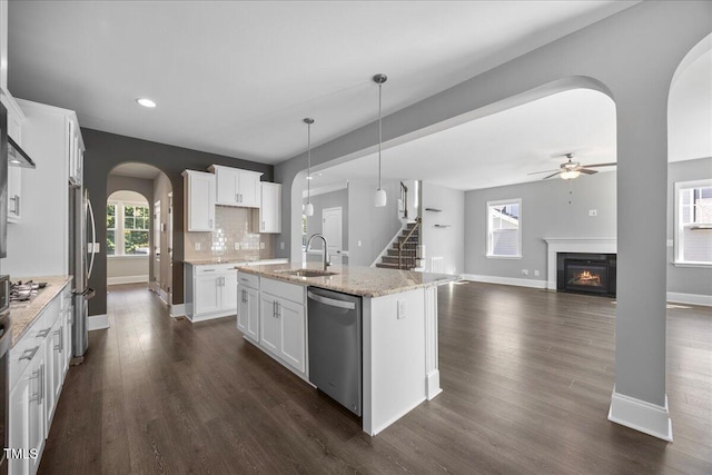 2223 Copper Pond Way, Fuquay Varina, NC 27526 - kitchen featuring arched walkways, appliances with stainless steel finishes, recessed lighting, ceiling fan, and dark wood-style flooring