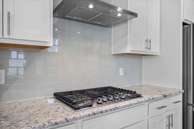 2223 Copper Pond Way, Fuquay Varina, NC 27526 - kitchen with wall chimney exhaust hood, appliances with stainless steel finishes, white cabinets, and decorative backsplash