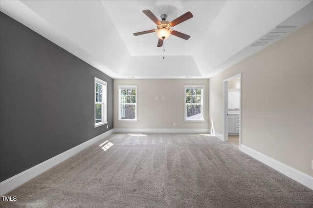 2223 Copper Pond Way, Fuquay Varina, NC 27526 - spare room with a raised ceiling, a ceiling fan, light colored carpet, and plenty of natural light
