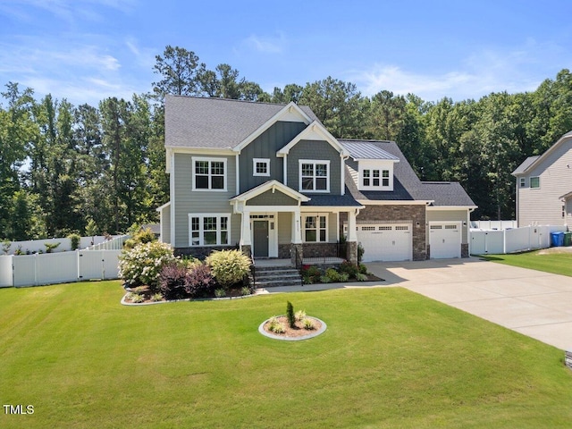 2223 Copper Pond Way, Fuquay Varina, NC 27526 - view of front of house with driveway, a garage, board and batten siding, and stone siding