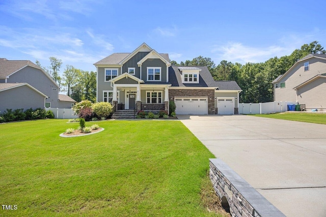2223 Copper Pond Way, Fuquay Varina, NC 27526 - view of front facade featuring concrete driveway, an attached garage, stone siding, covered porch, and board and batten siding