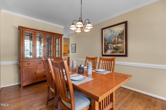 2104 Brockfield Ct, Raleigh, NC 27614 - dining room featuring a chandelier, wood finished floors, and ornamental molding