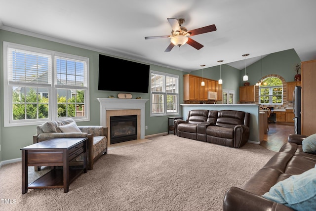 2104 Brockfield Ct, Raleigh, NC 27614 - living room with a ceiling fan, light carpet, ornamental molding, lofted ceiling, and a fireplace with flush hearth