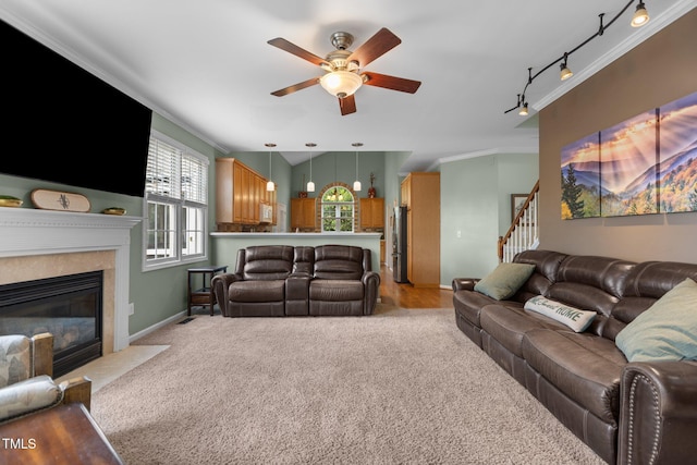 2104 Brockfield Ct, Raleigh, NC 27614 - living room with track lighting, a ceiling fan, light carpet, a high end fireplace, and stairs