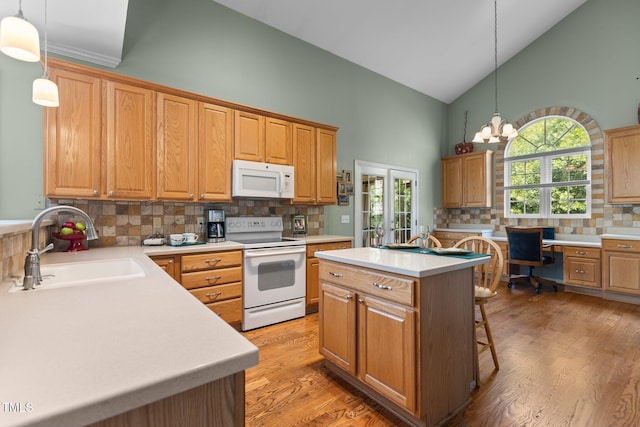 2104 Brockfield Ct, Raleigh, NC 27614 - kitchen with white appliances, high vaulted ceiling, backsplash, light countertops, and light wood finished floors