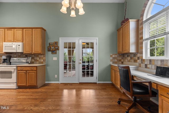 2104 Brockfield Ct, Raleigh, NC 27614 - kitchen with white appliances, a high ceiling, backsplash, a chandelier, and a desk