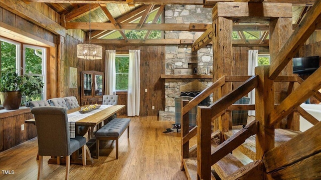 424 Roy Carver Rd, Semora, NC 27343 - dining area with a wooden ceiling with exposed beams, wood walls, high vaulted ceiling, hardwood / wood-style flooring, and a chandelier