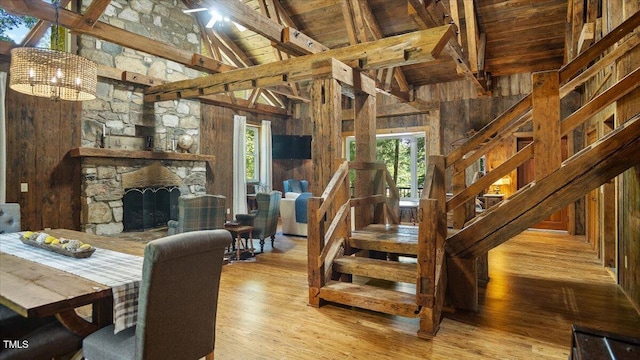 424 Roy Carver Rd, Semora, NC 27343 - dining area with a wood ceiling with exposed beams, wood finished floors, wooden walls, high vaulted ceiling, and a chandelier