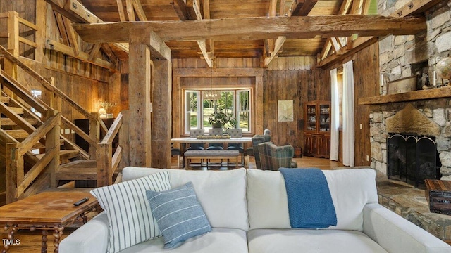 424 Roy Carver Rd, Semora, NC 27343 - living room featuring wood walls, a wood ceiling with exposed beams, and a stone fireplace