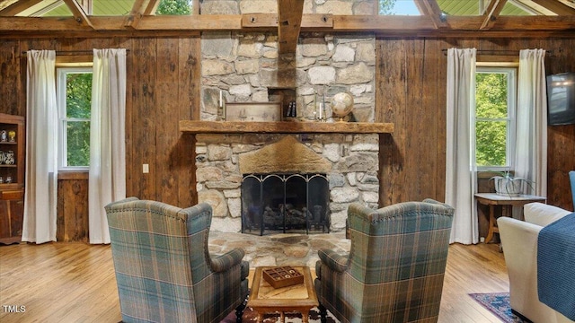 424 Roy Carver Rd, Semora, NC 27343 - living room with wood walls, wood finished floors, and a stone fireplace