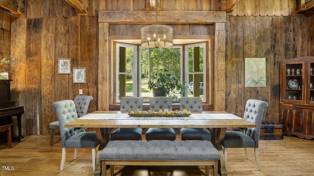 424 Roy Carver Rd, Semora, NC 27343 - dining room featuring wood walls, a chandelier, and light wood finished floors