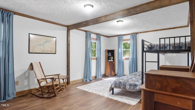 424 Roy Carver Rd, Semora, NC 27343 - bedroom featuring a textured ceiling, wood finished floors, ornamental molding, and beamed ceiling
