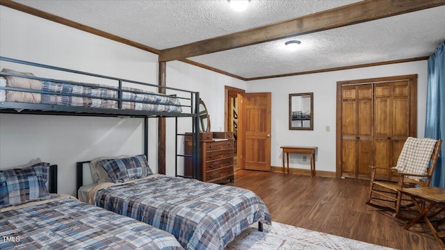 424 Roy Carver Rd, Semora, NC 27343 - bedroom featuring wood finished floors, beamed ceiling, a textured ceiling, and crown molding