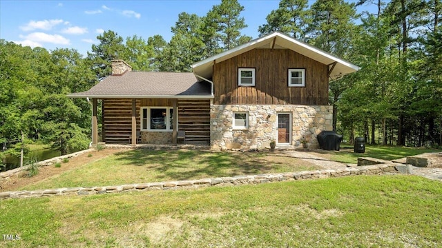 424 Roy Carver Rd, Semora, NC 27343 - log-style house with stone siding, a front yard, and a chimney
