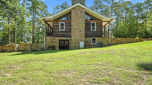 424 Roy Carver Rd, Semora, NC 27343 - back of house with stone siding, a chimney, a yard, and french doors