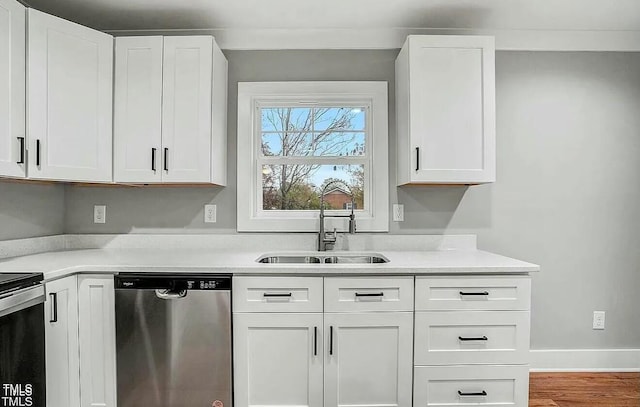 900 Woodrow St S, Wilson, NC 27893 - kitchen featuring dishwasher, light countertops, white cabinetry, and wood finished floors