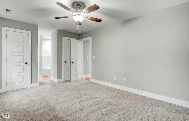900 Woodrow St S, Wilson, NC 27893 - unfurnished bedroom with carpet flooring, connected bathroom, and a ceiling fan