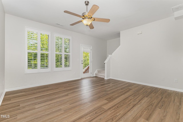 14309 Foxcroft Rd, Raleigh, NC 27614 - unfurnished living room featuring stairway, wood finished floors, and ceiling fan